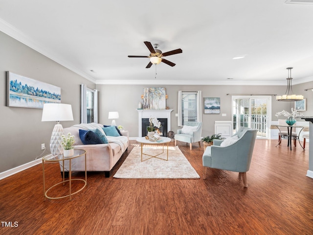 living room featuring hardwood / wood-style floors, ceiling fan, and crown molding