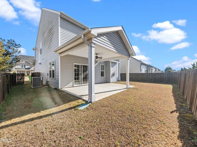 back of house featuring ceiling fan, cooling unit, a yard, and a patio