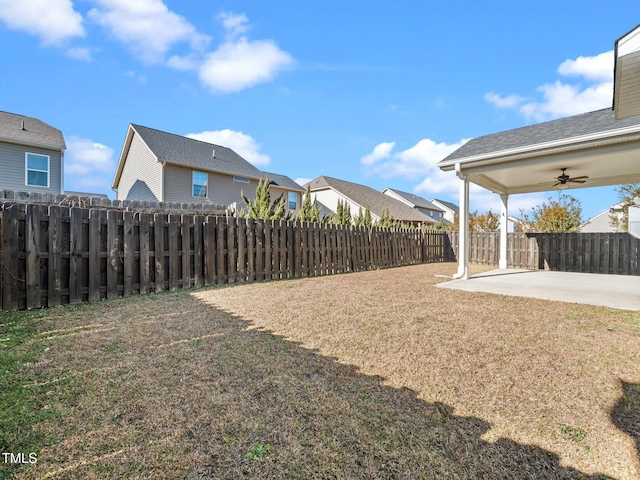 view of yard with ceiling fan and a patio