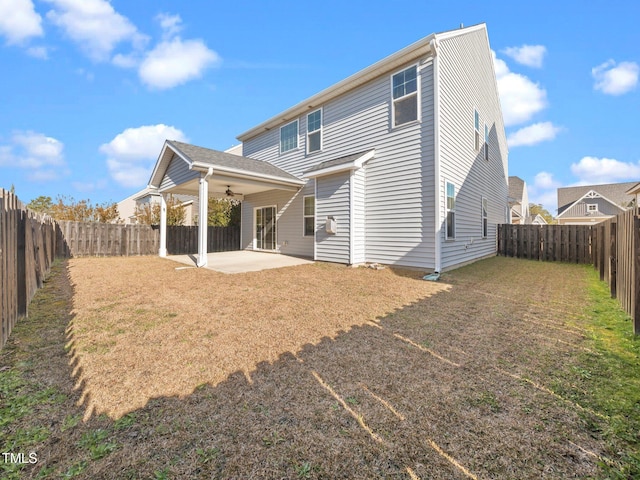 back of house featuring a patio area, ceiling fan, and a yard