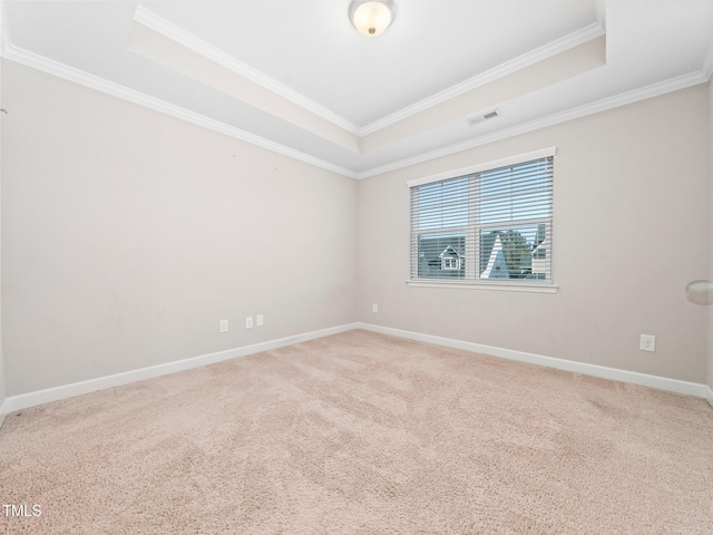 unfurnished room featuring carpet floors, a tray ceiling, and crown molding