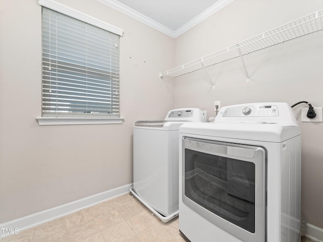 washroom with washer and clothes dryer and crown molding