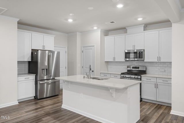 kitchen with stainless steel appliances, white cabinetry, and sink