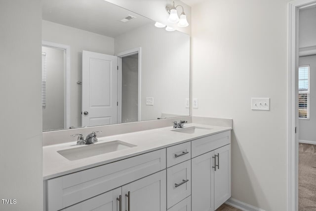 bathroom featuring a notable chandelier and vanity