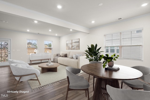 dining room with wood-type flooring and crown molding