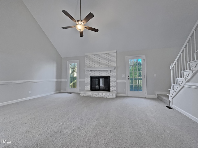 unfurnished living room featuring ceiling fan, light colored carpet, a fireplace, and high vaulted ceiling