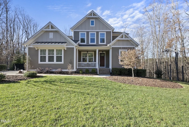 craftsman inspired home featuring a porch and a front lawn