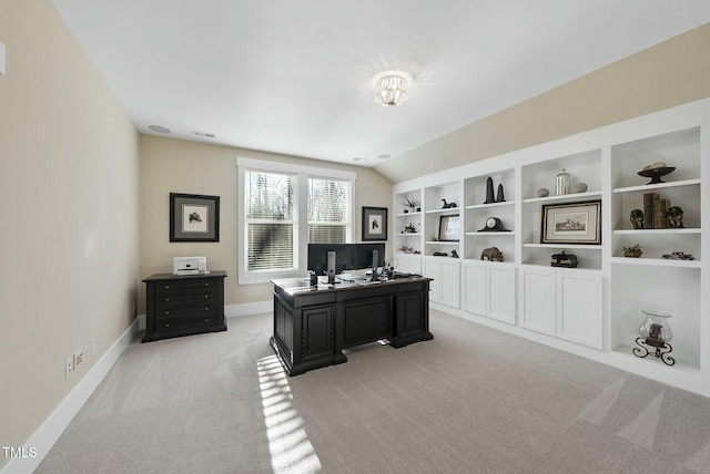 carpeted home office featuring lofted ceiling