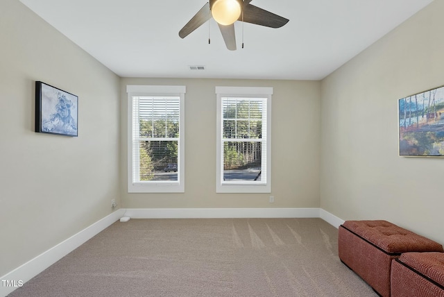 spare room featuring carpet flooring and ceiling fan