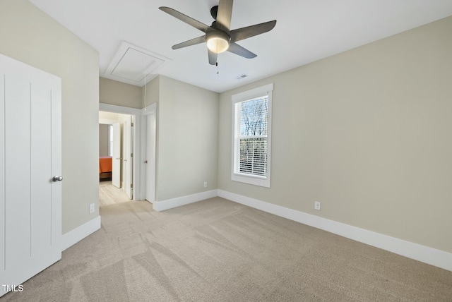 spare room featuring ceiling fan and light carpet