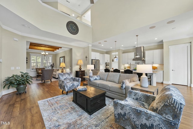 living room featuring light hardwood / wood-style floors and an inviting chandelier