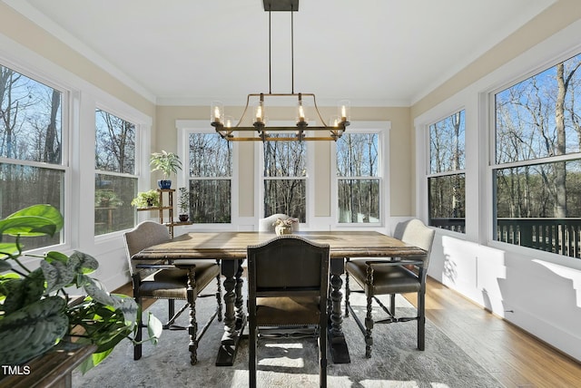 sunroom / solarium with a wealth of natural light and an inviting chandelier