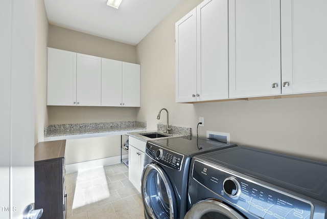 laundry room featuring washer and dryer, light tile patterned flooring, cabinets, and sink