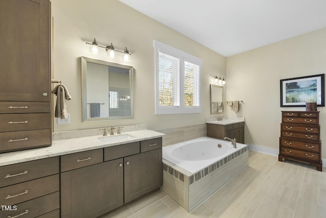 bathroom with tile patterned floors, vanity, and tiled tub