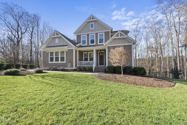 craftsman house featuring covered porch and a front yard