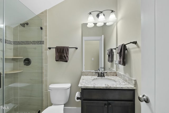 bathroom featuring vanity, toilet, and a shower with shower door