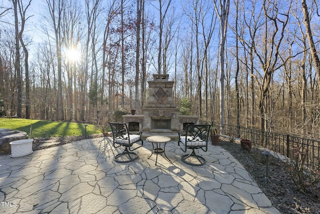 view of patio featuring an outdoor stone fireplace