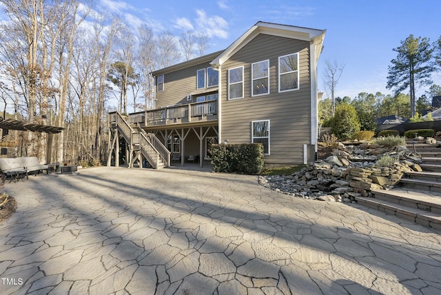 back of property with a wooden deck and cooling unit