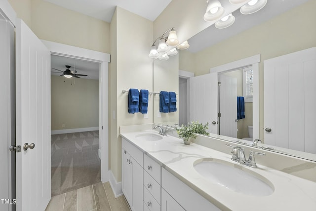 bathroom with ceiling fan, toilet, and vanity