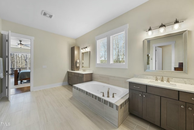 bathroom featuring ceiling fan, tile patterned flooring, vanity, and a healthy amount of sunlight