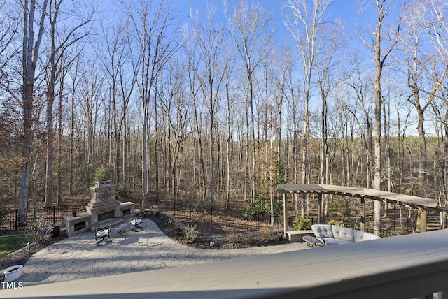 deck with an outdoor stone fireplace