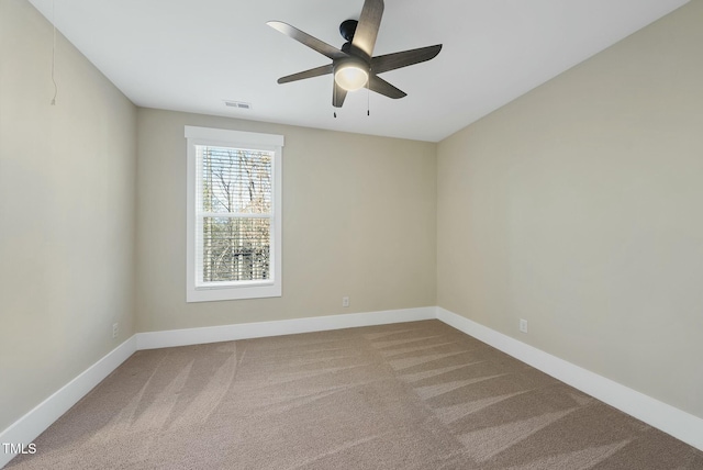 empty room with ceiling fan and carpet