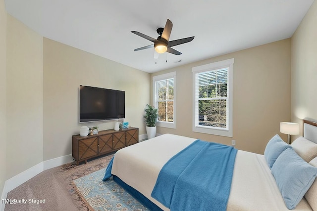 bedroom featuring light colored carpet and ceiling fan