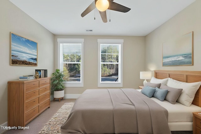 bedroom with ceiling fan and light colored carpet