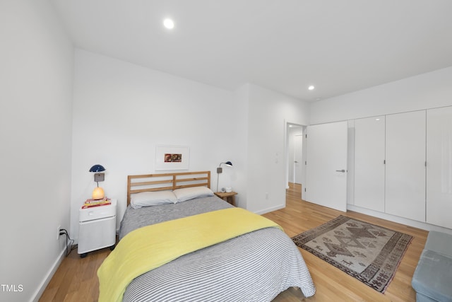 bedroom featuring hardwood / wood-style floors and a closet