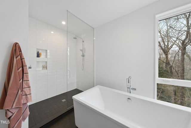 bathroom featuring shower with separate bathtub and tile patterned flooring