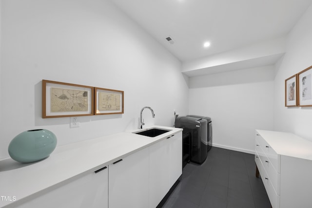 laundry area with cabinets, independent washer and dryer, and sink