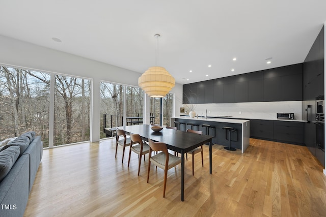 dining space with light wood-type flooring