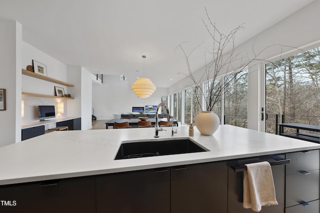 kitchen with hanging light fixtures, a kitchen island, and sink