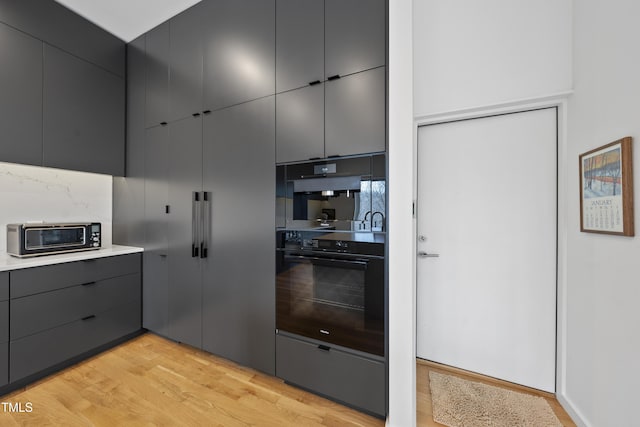 kitchen with light hardwood / wood-style floors and double oven