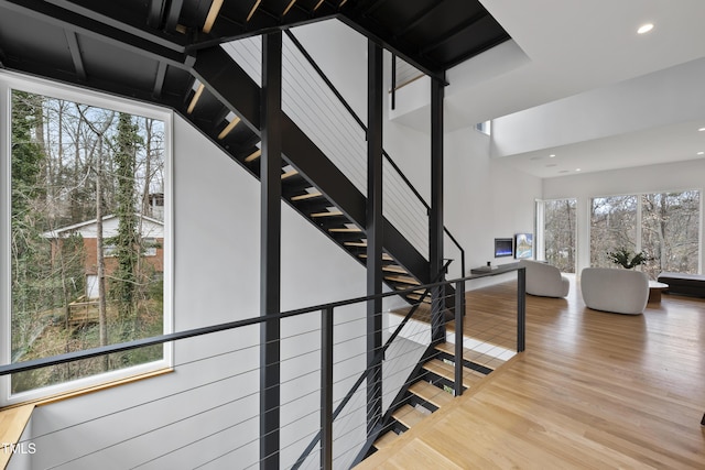 stairs featuring hardwood / wood-style floors