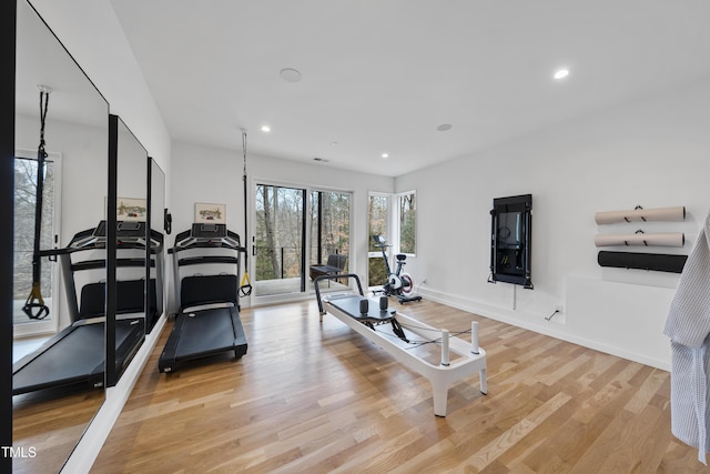 workout room with light hardwood / wood-style flooring