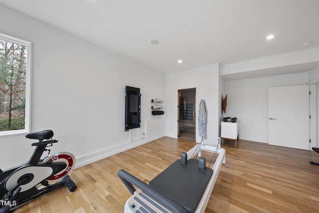 exercise area with a healthy amount of sunlight and hardwood / wood-style floors