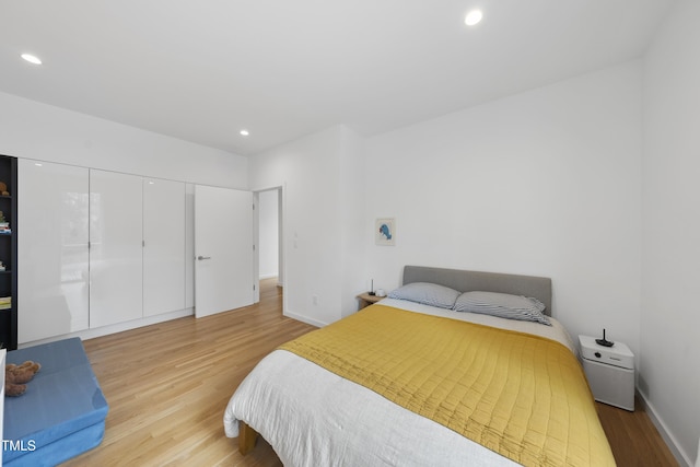 bedroom with a closet and light hardwood / wood-style flooring