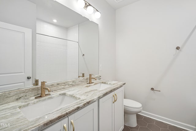 bathroom featuring toilet, tile patterned floors, and vanity