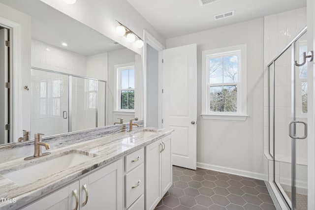 bathroom with walk in shower, vanity, tile patterned floors, and plenty of natural light