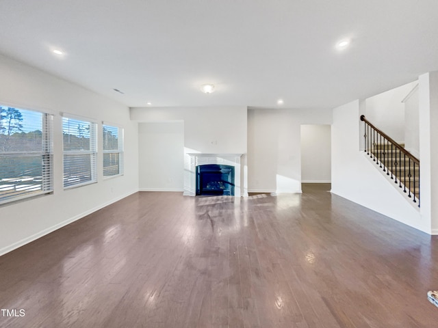 unfurnished living room featuring dark wood-type flooring