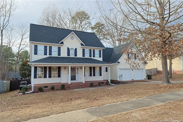 colonial inspired home with covered porch and a garage