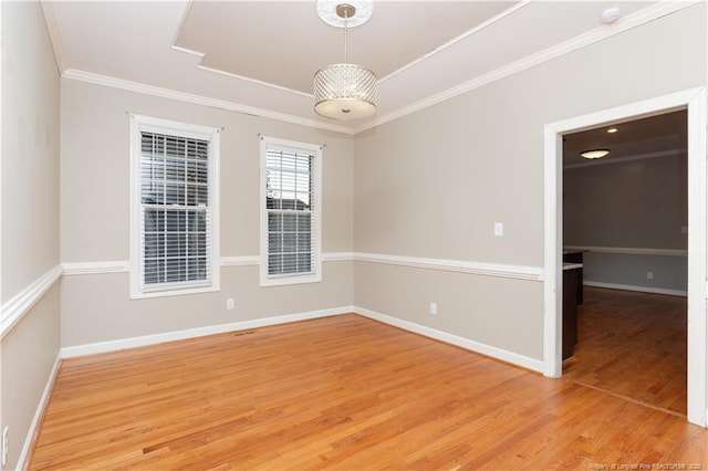 unfurnished room with hardwood / wood-style flooring and ornamental molding