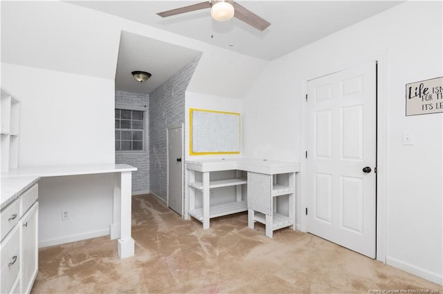 home office with light colored carpet, ceiling fan, and lofted ceiling