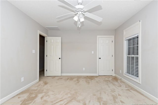 unfurnished room featuring ceiling fan and light colored carpet