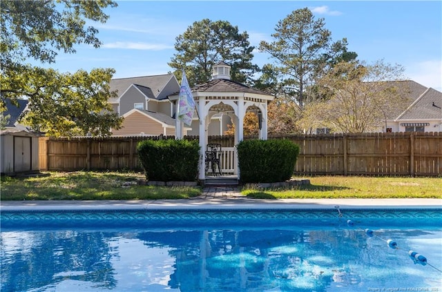 view of swimming pool featuring a gazebo and a storage unit