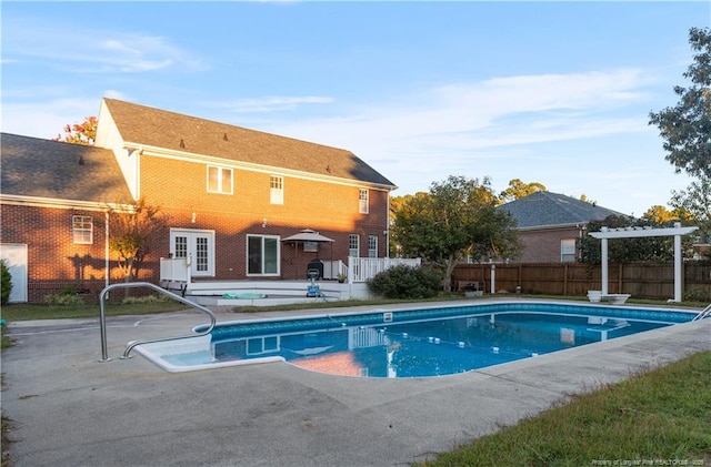 view of pool with a patio and french doors