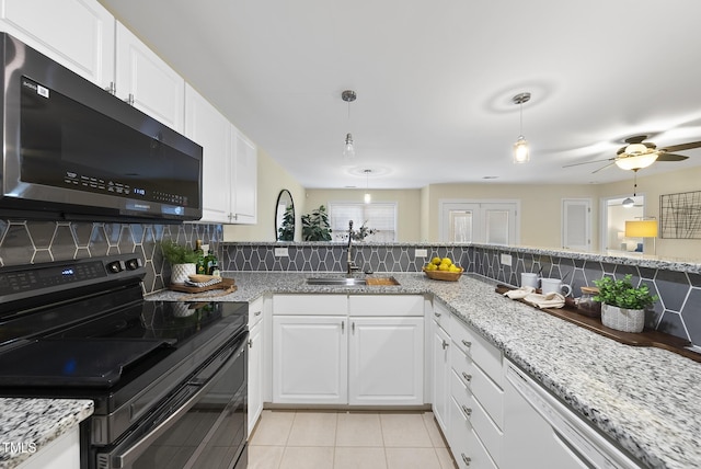 kitchen with white cabinetry, sink, pendant lighting, and black range with electric cooktop