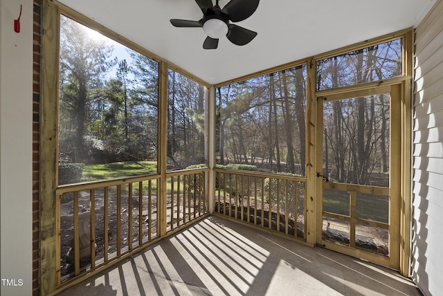 unfurnished sunroom featuring ceiling fan