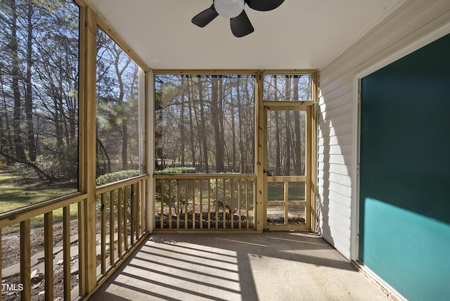 unfurnished sunroom featuring ceiling fan